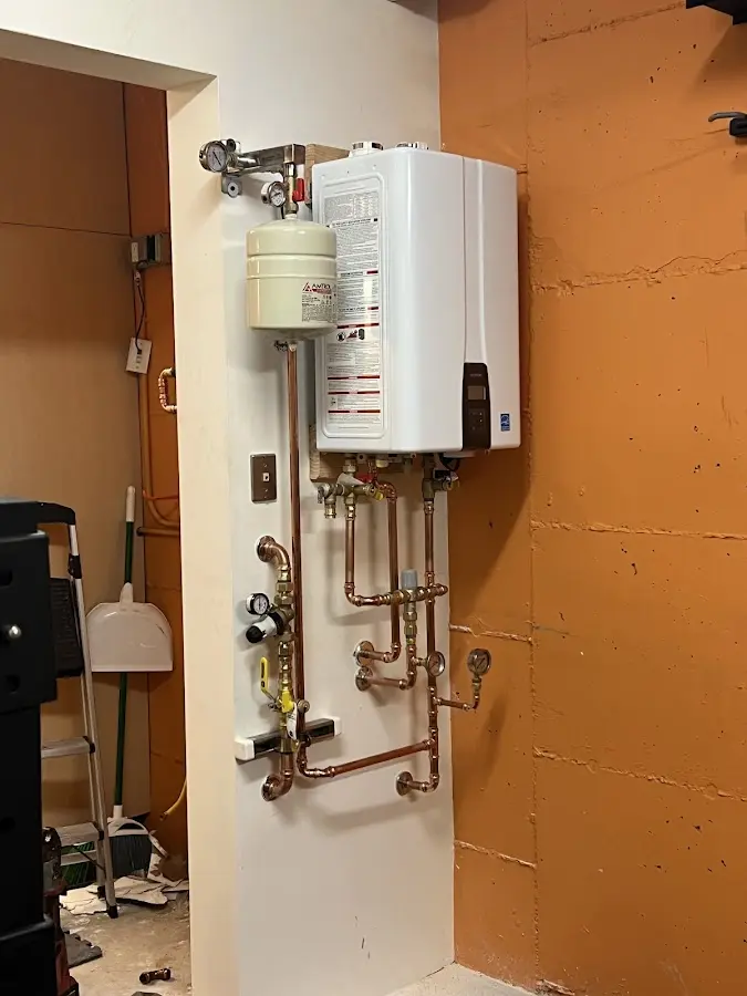 Plumbing technician inspecting water heater connections in Lamesa
